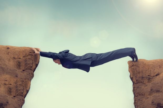 Man in a suit bridging a chasm, symbolising gaps in graduate earnings outcomes