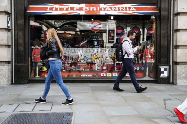 People walking past Little Britannia shop, London People walking past Little Britannia shop, London