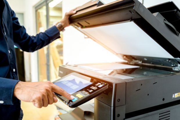Bussiness man Hand press button on panel of printer