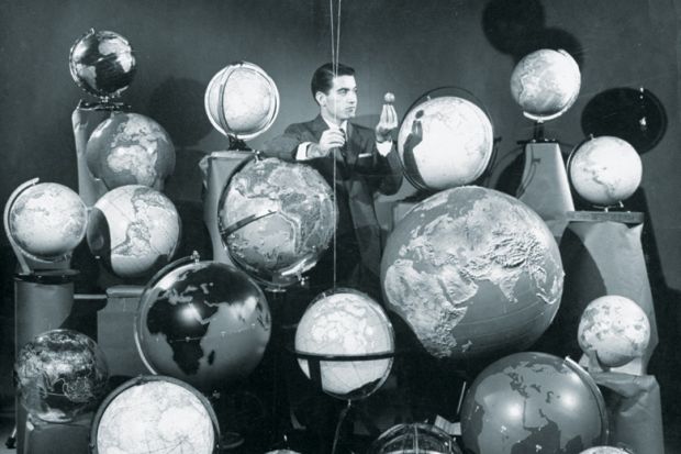 Businessman surrounded by globes of the world