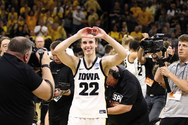 Caitlin Clark gestures to the crowd Caitlin Clark #22 of the Iowa Hawkeyes gestures to the crowd as she leaves the court after the game against the West Virginia Mountaineers during their second round match-up in the 2024 NCAA Division 1 Women's Basketball Championship
