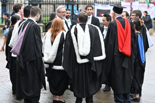 Cambridge, England, 30_November_2024, UK. Students gather on Kings Parade after attending graduation day at St Marys church along Kings Parade in Cambridge,