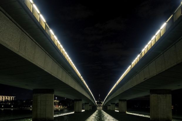 Canberra, Australia - Sep 8, 2018 Night view of the Commonwealth Avenue bridges from underneath. Parliament House in the distance. Canberra, Australia - Sep 8, 2018 Night view of the Commonwealth Avenue bridges from underneath. Parliament House in the distance.