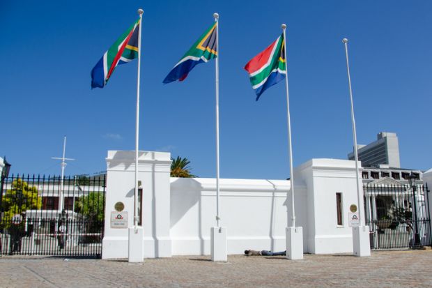 A homeless person sleeping under the South Africa flag at the Cape Town Parliament A homeless person sleeping under the South Africa flag at the Cape Town Parliament