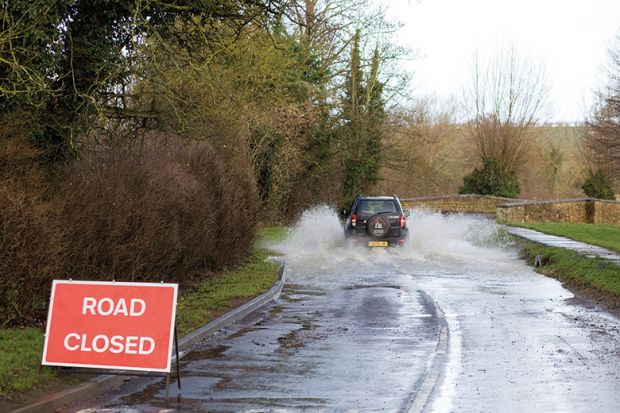 Car driving on flooded road