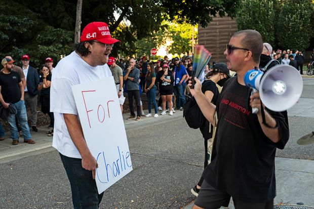 A man holds a sign that says "For Charlie" as people protest outside the "American Comeback Tour" event at Northrop Auditorium on the University of Minnesota campus on 22 September, 2025. The event was held after the assassination of Charlie Kirk. A man holds a sign that says "For Charlie" as people protest outside the "American Comeback Tour" event at Northrop Auditorium on the University of Minnesota campus on 22 September, 2025. The event was held after the assassination of Charlie Kirk.