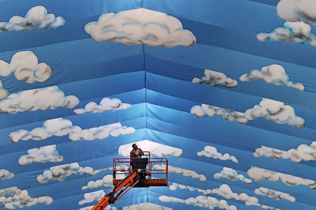 Cherrypicker against cloud mural Cherrypicker against cloud mural