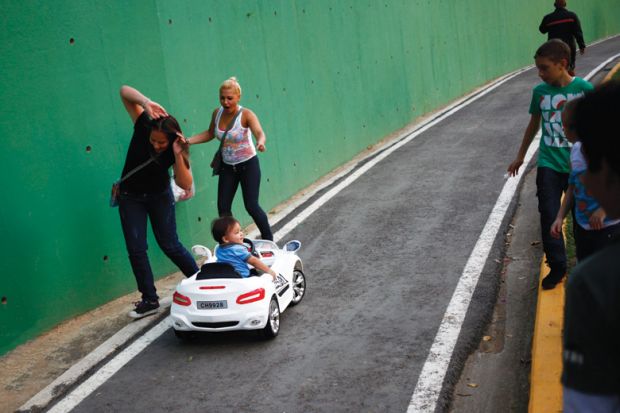 Child drives miniature car into people Child drives miniature car into people