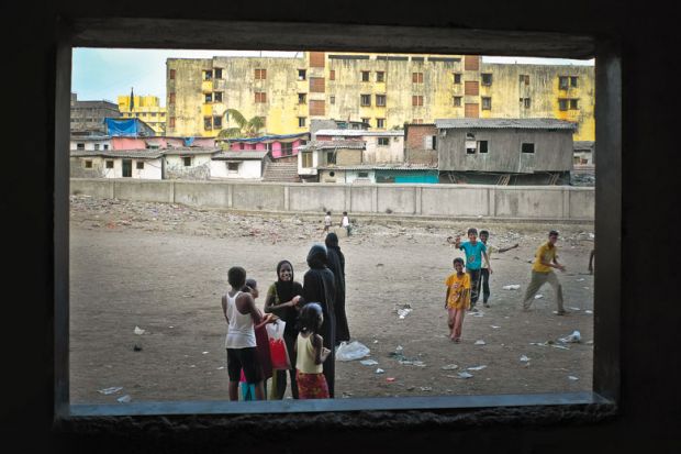 Children playing, viewed through open window, Dharavi, Mumbai Children playing, viewed through open window, Dharavi, Mumbai