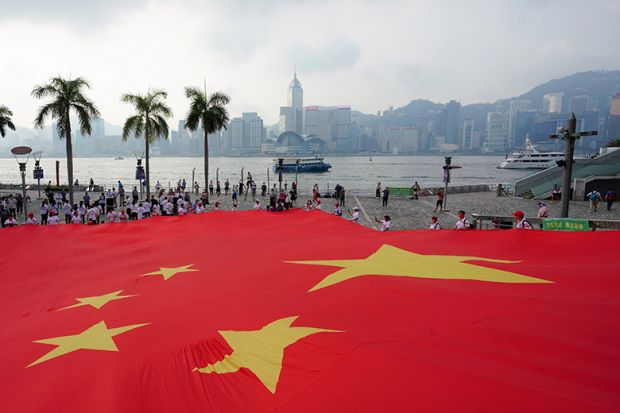 A giant Chinese national flag is displayed at Tsim Sha Tsui to celebrate the 72nd anniversary of the founding of the People’s Republic of China on 1 October 2021 in Hong Kong, China.