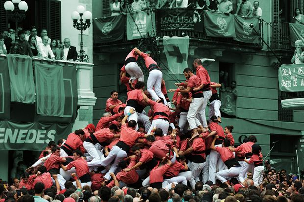 People fall as they attempt to form a “castell” during an exhibition of the human towers, or castells, in Vilafranca del Penedes, 2016 People fall as they attempt to form a “castell” during an exhibition of the human towers, or castells, in Vilafranca del Penedes, 2016