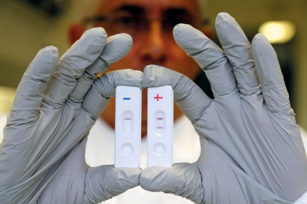 Researcher holds Ebola diagnostic tests Researcher holds Ebola diagnostic tests