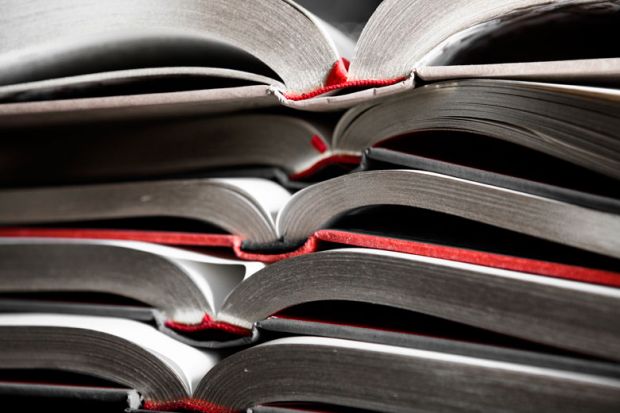 Collection of bound essays piled high Collection of bound essays piled high