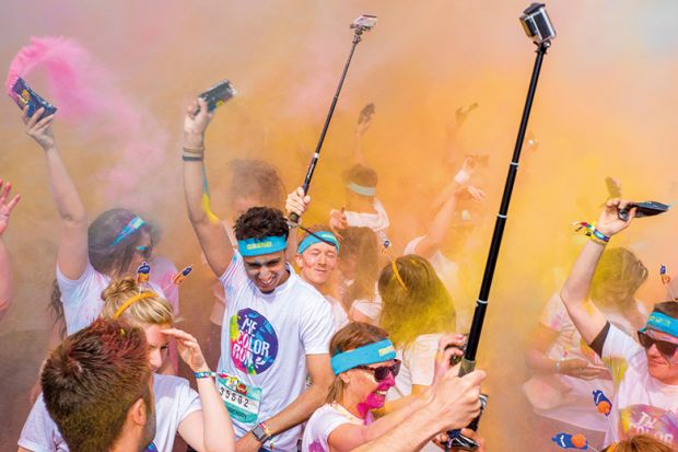 Birmingham Color run 2016. Young people with selfie sticks Birmingham Color run 2016. Young people with selfie sticks