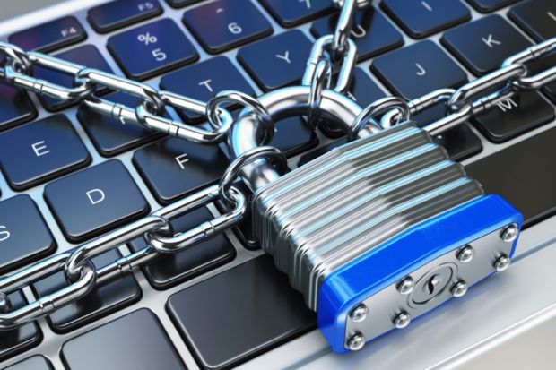 Computer keyboard locked with padlock and chain Computer keyboard locked with padlock and chain