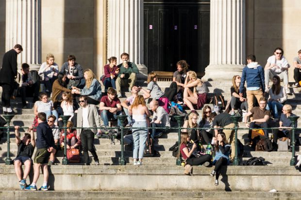 Crowd of University College London (UCL) students relaxing in sunshine Crowd of University College London (UCL) students relaxing in sunshine