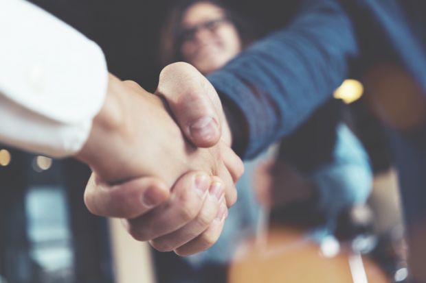 Hands shaking to make a deal