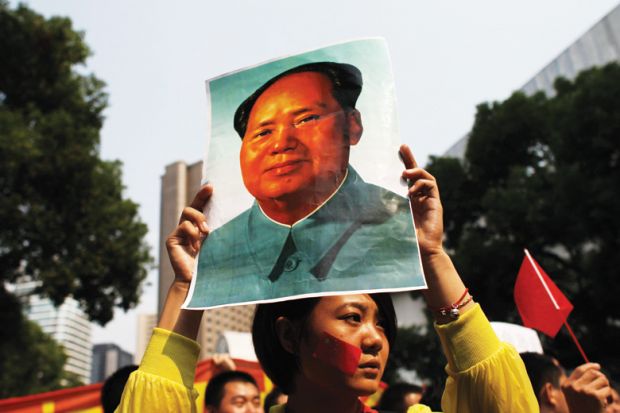 Demonstrator holding poster of Mao Zedong (Mao Tse-tung), Shanghai Demonstrator holding poster of Mao Zedong (Mao Tse-tung), Shanghai