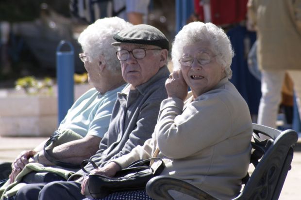 Elderly man and women sitting on bench Elderly man and women sitting on bench