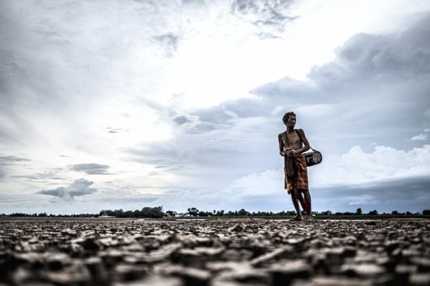 Elderly men look for fish on dry ground
