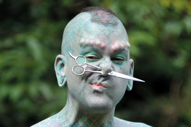 Erik Sprague (The Lizardman) with scissors through nose Erik Sprague (The Lizardman) with scissors through nose