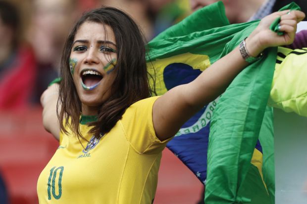 Female Brazilian football/soccer fan celebrating with flag of Brazil, Best universities in Latin America Female Brazilian football/soccer fan celebrating with flag of Brazil, Best universities in Latin America