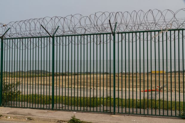 Fence with razor wire guarding French ferry terminal Fence with razor wire guarding French ferry terminal