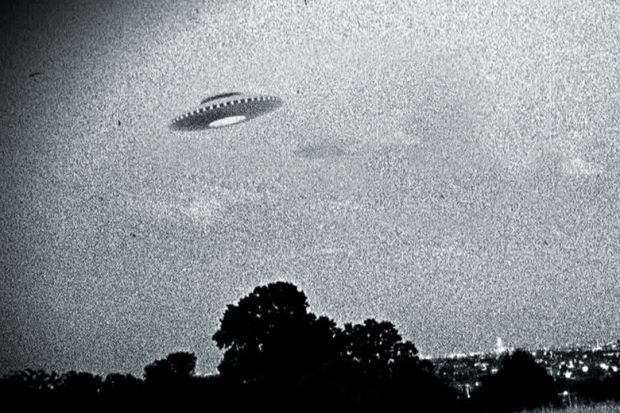 A flying saucer in the night sky A flying saucer in the night sky