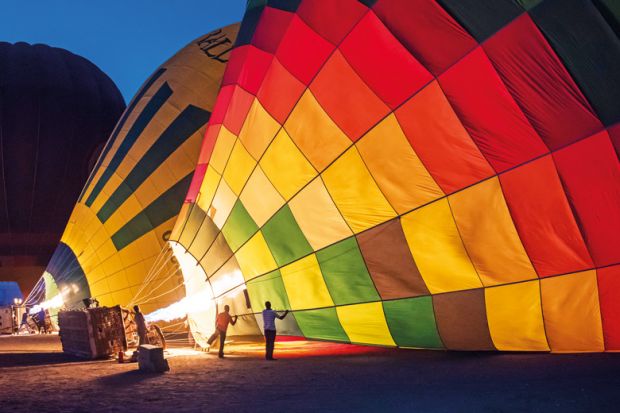 Gas burners filling hot air balloons at dawn Gas burners filling hot air balloons at dawn