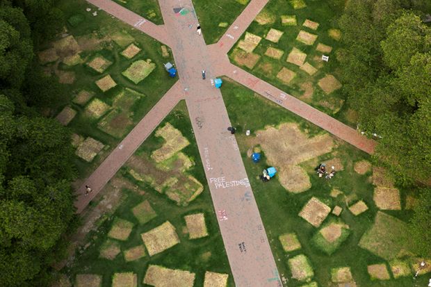 A drone view shows marks left by tents next to signs as people pack up to leave a protest encampment, organised in support of Palestinians in Gaza, after protesters agreed to voluntarily end the camp at the University of Washington in Seattle, 20 May 2024