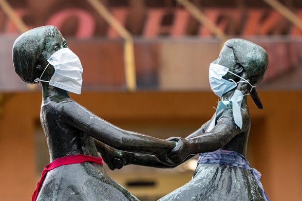 The two female heads of a bronze figure wear a protective face mask on April 3, 2020 in Jena, Germany The two female heads of a bronze figure wear a protective face mask on April 3, 2020 in Jena, Germany