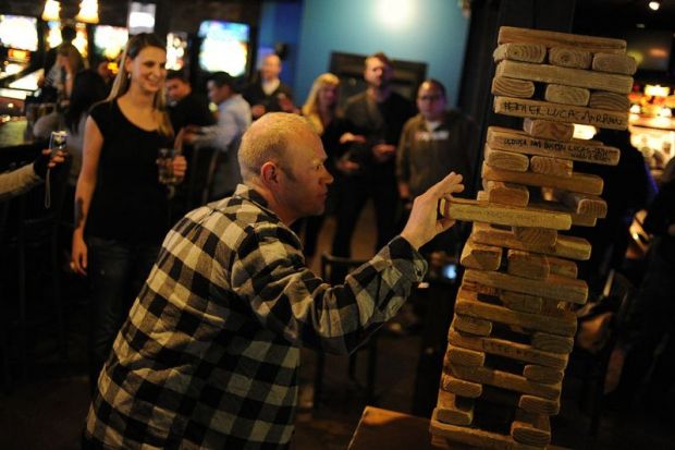 Troy Benson eases a block out an oversized Jenga game