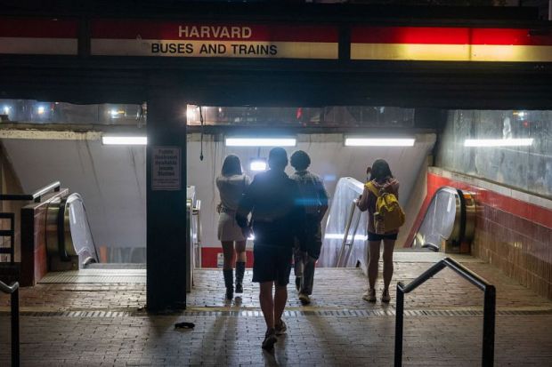 People enter the Harvard transit station on May 27, 2025 in Cambridge, Massachusetts