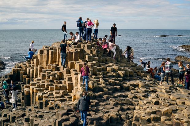 Crowd of people on the Giant's Causeway, Northern Ireland, illustrating how students may still look elsewhere to study if the Maximum Student Number (MaSN) cap was relaxed.