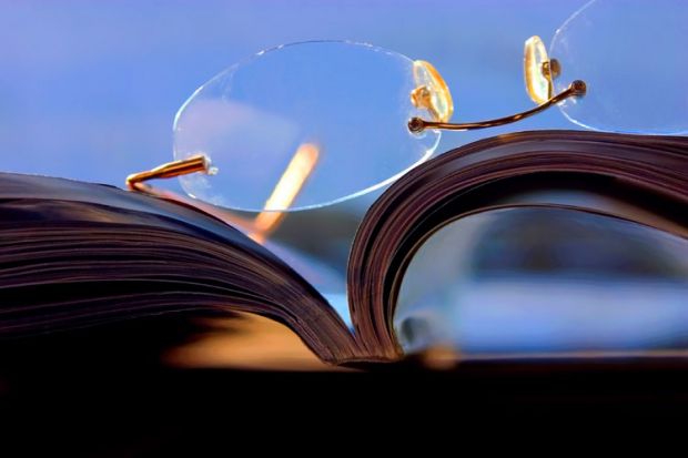 Glasses lying on top of a journal