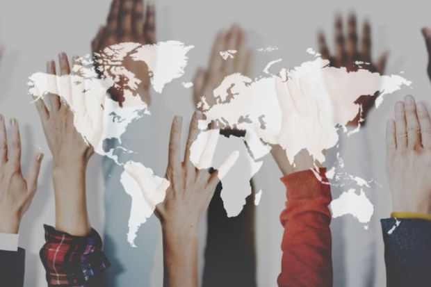 Hands raised, superimposed on a map of the world Hands raised, superimposed on a map of the world