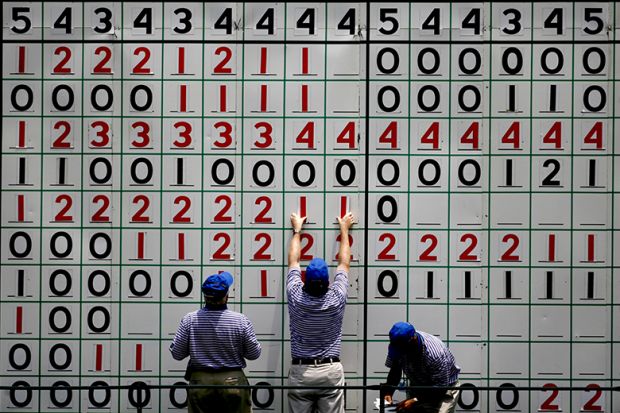 Course volunteers update the main leader board during a golf tournament. To illustrate ‘inconsistency’ fears after REF retreat on environment metrics.