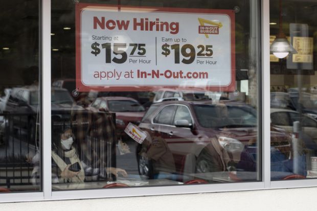 Now Hiring sign with promised hourly wage rates is seen at one of the In-N-Out Burger chain restaurants in Grants Pass, Oregon, amidst the labour shortage. Grants Pass, OR, USA - Mar 19, 2022 Now Hiring sign with promised hourly wage rates is seen at one of the In-N-Out Burger chain restaurants in Grants Pass, Oregon, amidst the labor shortage.