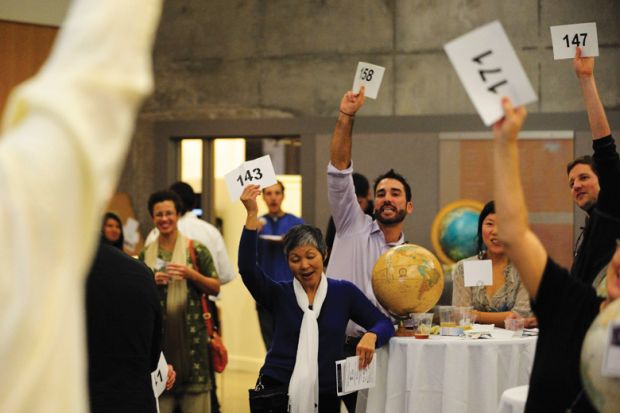 Group of people bidding at auction Group of people bidding at auction