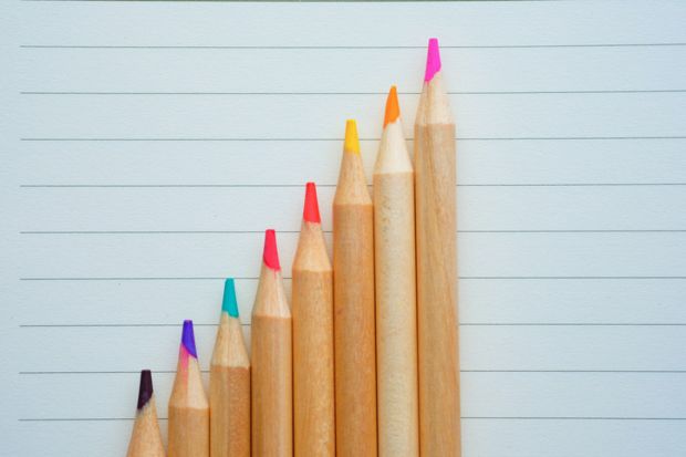 growth graph with pencils on paper