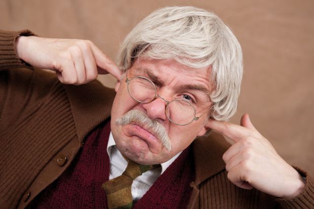 Grumpy man with fingers in ears Grumpy man with fingers in ears