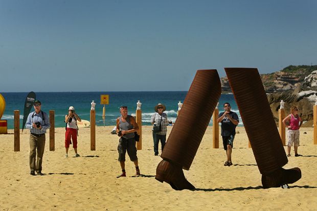 Steel sculpture 'Pedestrian Portrait' at Tamarama Beach, Sydney, Australia. The sculpture shows just a pair of lower legs, illustrating that there has been a spike in the number of student visa applications to Australia that have been withdrawn.