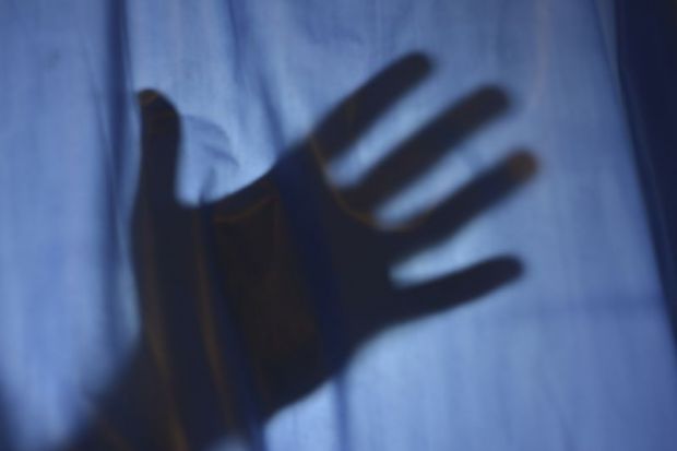 Hand behind sheet