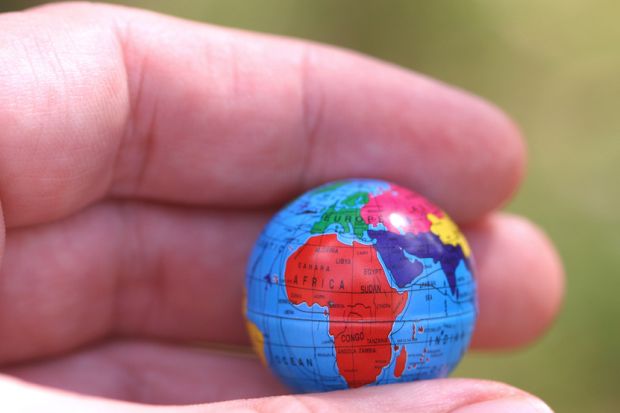 Hand holding globe showing Africa Hand holding globe showing Africa