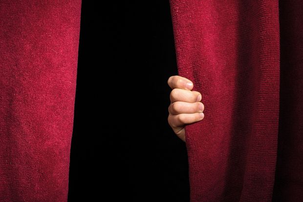 A hand on a theatre curtain A hand on a theatre curtain