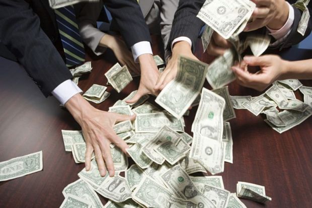 Hands grabbing dollar bills