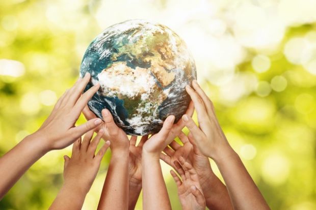 Many hands holding up the Earth, symbolising collaboration to meet the SDGs