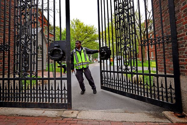 A security guard closing the Johnston Gate at Harvard University. As an illustration that Trump’s anti-DEI agenda ‘already having grave impact’, with some institutions shut down initiatives or continue them in a different guise.