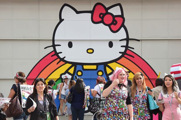 Hello Kitty mural with people in a group of people in front of it Hello Kitty mural with people in a group of people in front of it