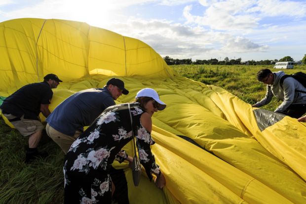 Helping the ground crew folding up the balloon Helping the ground crew folding up the balloon
